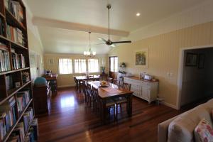 a dining room and living room with a table and chairs at Gridley Homestead B&B in Eumundi