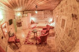 a large room with a bed and a table and chairs at Mosaic Cave Hotel in Göreme