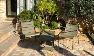 two chairs sitting in front of a house at La Cour Sainte Catherine demeure de charme in Honfleur
