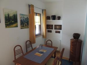 a dining room with a wooden table and chairs at Apartma Bovec in Bovec +3 photos