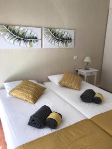 a large white bed with three pillows on it at Apartamento T&T Ocean - Foz Palace Residence Spa in Portimão