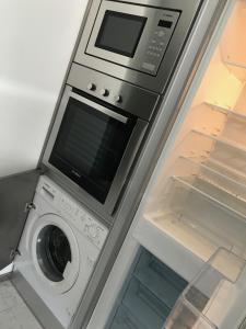 a refrigerator with a microwave and a washing machine at Apartamento T&T Ocean - Foz Palace Residence Spa in Portimão +35 photos