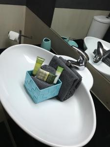 a bathroom sink with a box of soap and towels at Apartamento T&T Ocean - Foz Palace Residence Spa in Portimão