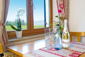 a table with two champagne bottles and glasses on it at Altensberger Hof in Gestratz