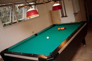 a pool table in a room with two lights at Condado Hotel Casino Santo Tome in Santo Tomé