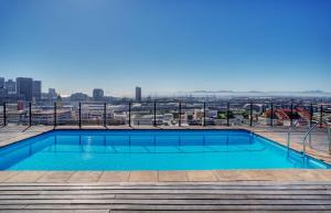 a swimming pool on the roof of a building at Trendy Cape Town CBD Apartment in Cape Town