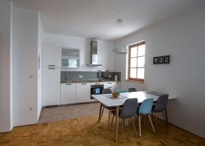 a kitchen and dining room with a table and chairs at Krona Apartments in Bovec