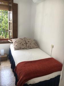 Postel nebo postele na pokoji v ubytování La casita de la ciudad