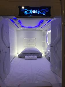 エカテリンブルクにあるカプセル ホテル オリオンのベッドルーム1室(紫色の照明が付いたベッド1台付)