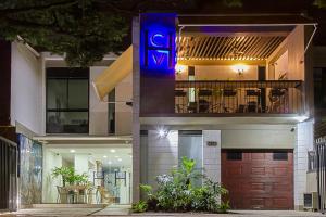 a house with a blue sign on the front of it at Hotel Casa Vallecaucana in Cali