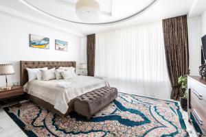 a bedroom with a large bed and a large rug at Villa Loreto in Shagan