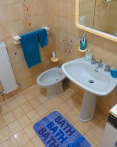 a bathroom with a sink and a toilet and a mirror at Casa Lea in Ventimiglia