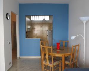 a dining room with a table and a blue wall at Casa Lea in Ventimiglia +20 photos