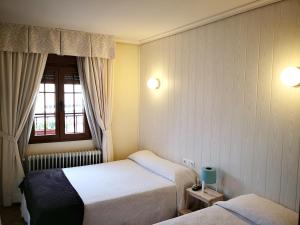 Postel nebo postele na pokoji v ubytování Hostal Alcántara