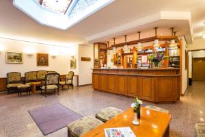 a lobby with a waiting area and a waiting room at Geneva Hotel in Sofia