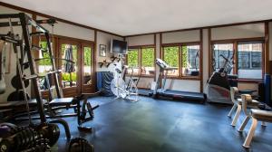 a gym with several treadmills and exercise machines at East Hampton Art House Bed and Breakfast in East Hampton