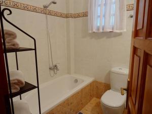 a bathroom with a tub and a toilet and a sink at Wood and Stone Villa in Sani Beach +30 photos