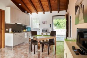a kitchen and dining room with a table and chairs at New Attic Lake View 4 in Varenna