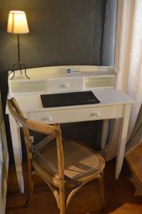 a white desk with a chair and a lamp at La Chamberte in Villeneuve-lès-Béziers +43 photos