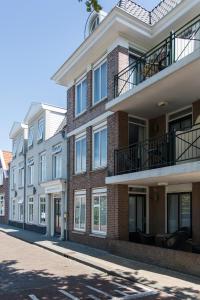 a row of buildings on a city street at B's Strandappartementen in Domburg
