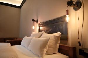 a hotel room with a bed with white pillows at Linnen Luxx Apartment in Berlin