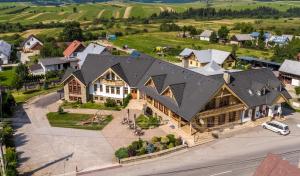 an aerial view of a large house with a large roof at Hostinec Babia hora in Oravská Polhora