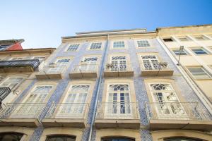 a blue and white building with white windows at Almada Story Apartments by Porto City Hosts in Porto