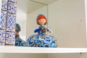 a shelf with two blue and white vases on it at Almada Story Apartments by Porto City Hosts in Porto