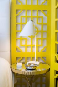 a lamp on a table next to a bed at Almada Story Apartments by Porto City Hosts in Porto