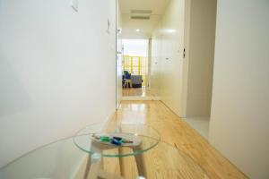 a glass table in the middle of a room at Almada Story Apartments by Porto City Hosts in Porto