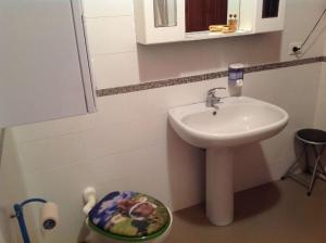 a small bathroom with a sink and a toilet at Bed & Breakfast da Charlie in LʼAquila