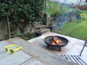 a fire pit on a patio with a table at Casa Verità in San Daniele del Friuli