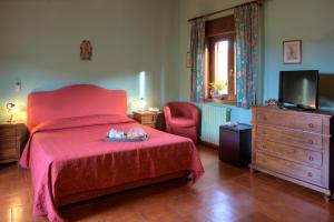 Ένα ή περισσότερα κρεβάτια σε δωμάτιο στο Agriturismo Al Poggetto
