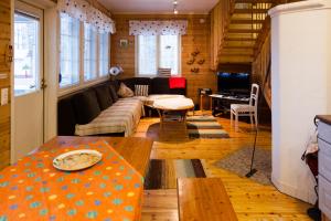 a living room with a couch and a table at Villa North Karelia by offerhut 25 in Onkamon Kannas