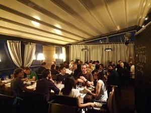 a group of people sitting at tables in a restaurant at Apartments Marmont in Split