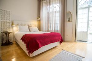a bedroom with a large bed with a red blanket at Almada Story Apartments by Porto City Hosts in Porto
