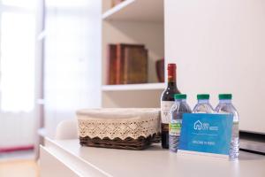 three bottles of water and a basket on a counter at Almada Story Apartments by Porto City Hosts in Porto