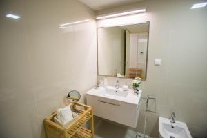 a bathroom with a sink and a mirror at Almada Story Apartments by Porto City Hosts in Porto