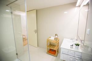 a bathroom with a glass shower and a sink at Almada Story Apartments by Porto City Hosts in Porto