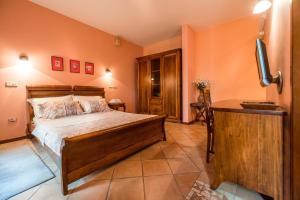 a bedroom with a bed and a flat screen tv at Guest House Forza Lux in Kotor