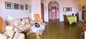 a living room with a couch and a table at Pandora 1 in Maccagno Inferiore