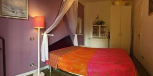 a bedroom with a bed with a red blanket at Pandora 1 in Maccagno Inferiore +15 photos