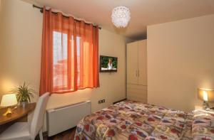 Posteľ alebo postele v izbe v ubytovaní Hotel Il Giardino