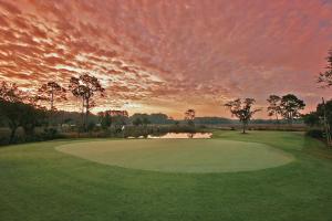 a view of a golf course with a sunset at The King and Prince Beach & Golf Resort in Saint Simons Island