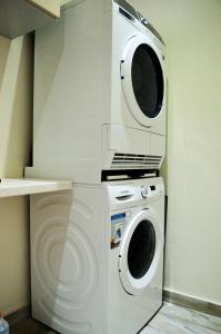a washer and a washing machine in a kitchen at Ammos Beachfront Luxury Apartment in Amoudara Herakliou