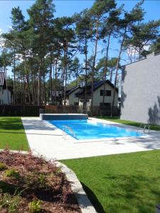 a swimming pool in the yard of a house at Apartament Scandi N*.9 in Pobierowo