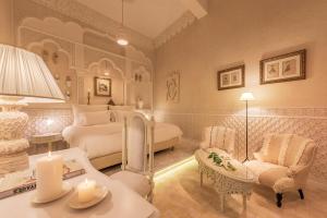 a bedroom with a bed and a couch and a table at Riad Karmela Princesse in Marrakesh