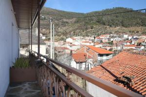 a balcony with a view of a city at Casa do Ti Latoeiro in Torre de Moncorvo