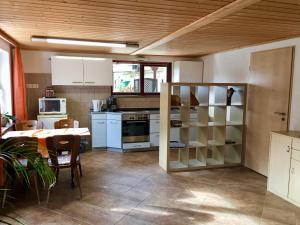 a kitchen and dining room with a table and a table and chairs at Ferienwohnung Am Grünbach in Kurort Rathen