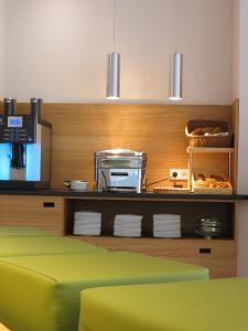 a kitchen with a shelf with food on it at Hotel Neuthor in Ulm